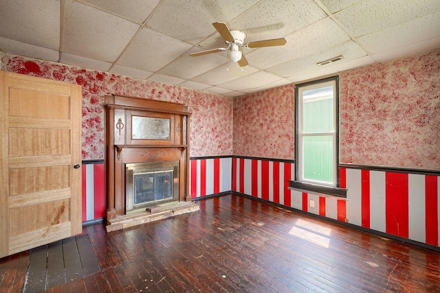 514 S Columbus St, Lancaster, OH 43130 - unfurnished living room with wallpapered walls, a paneled ceiling, wainscoting, hardwood / wood-style floors, and a ceiling fan