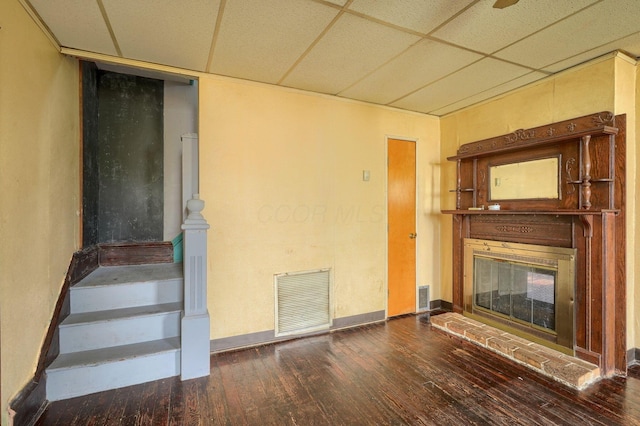 514 S Columbus St, Lancaster, OH 43130 - unfurnished living room with a paneled ceiling, hardwood / wood-style flooring, a brick fireplace, and stairway
