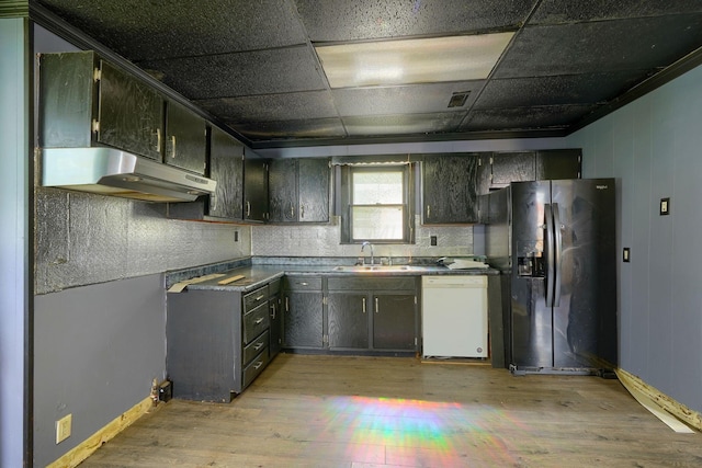 514 S Columbus St, Lancaster, OH 43130 - kitchen featuring dishwasher, under cabinet range hood, black fridge with ice dispenser, light wood-style flooring, and dark countertops