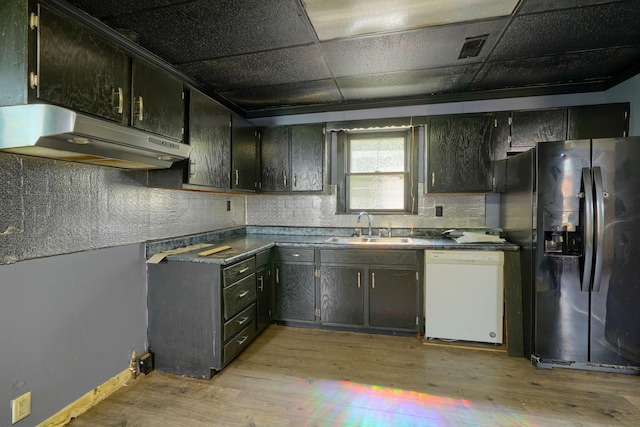 514 S Columbus St, Lancaster, OH 43130 - kitchen featuring dishwasher, black refrigerator with ice dispenser, under cabinet range hood, light wood finished floors, and dark countertops