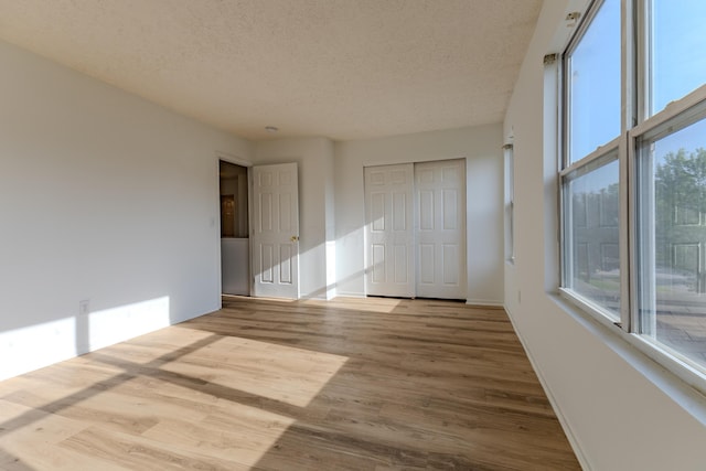 5480 Rothermund Dr, Canal Winchester, OH 43110 - unfurnished bedroom featuring wood finished floors, a textured ceiling, and a closet