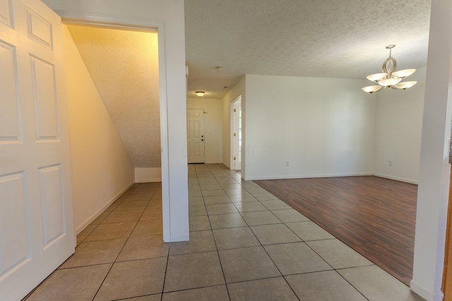 5480 Rothermund Dr, Canal Winchester, OH 43110 - tiled spare room featuring a chandelier and a textured ceiling