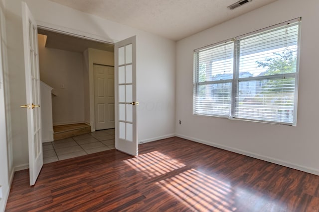 5480 Rothermund Dr, Canal Winchester, OH 43110 - unfurnished bedroom featuring wood finished floors, french doors, and a textured ceiling