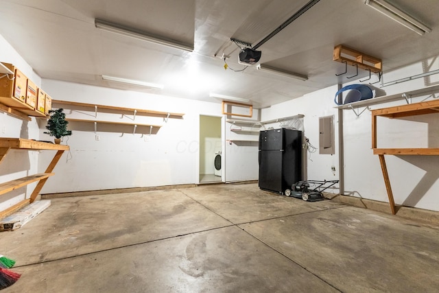 5480 Rothermund Dr, Canal Winchester, OH 43110 - garage featuring electric panel, freestanding refrigerator, a garage door opener, and washer / dryer