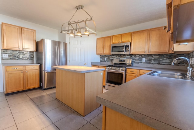 5480 Rothermund Dr, Canal Winchester, OH 43110 - kitchen featuring appliances with stainless steel finishes, decorative backsplash, a center island, and light tile patterned floors