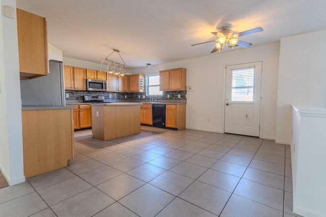 5480 Rothermund Dr, Canal Winchester, OH 43110 - kitchen with appliances with stainless steel finishes, tasteful backsplash, a ceiling fan, a kitchen island, and light tile patterned floors