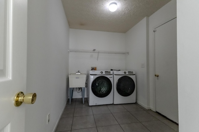 5480 Rothermund Dr, Canal Winchester, OH 43110 - washroom featuring washing machine and dryer, a textured ceiling, and light tile patterned floors