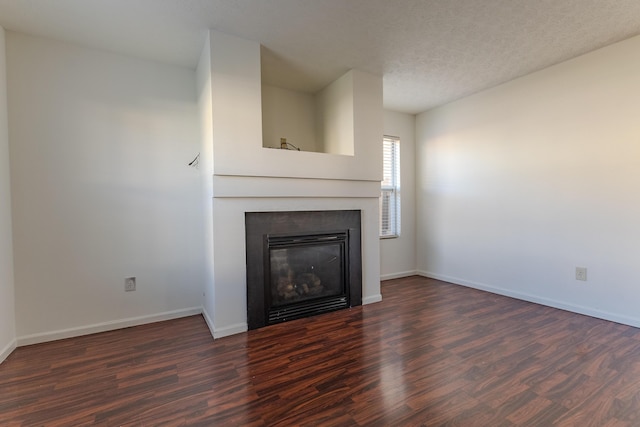 5480 Rothermund Dr, Canal Winchester, OH 43110 - unfurnished living room featuring dark wood-style floors and a glass covered fireplace