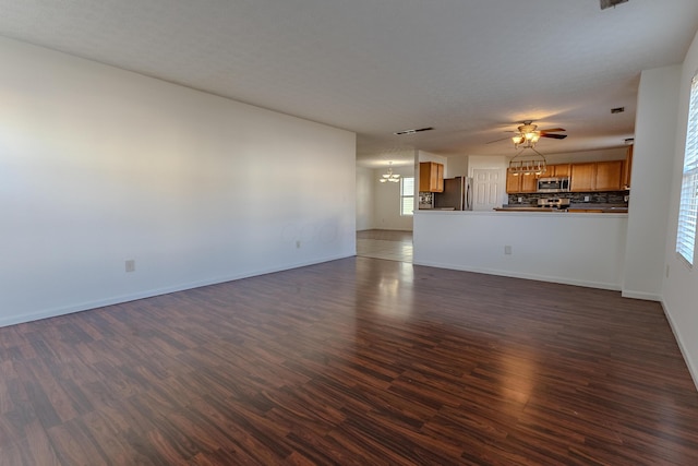 5480 Rothermund Dr, Canal Winchester, OH 43110 - unfurnished living room with a chandelier, dark wood finished floors, and a ceiling fan