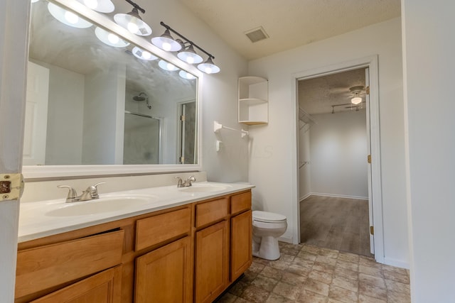 5480 Rothermund Dr, Canal Winchester, OH 43110 - full bath featuring a stall shower, double vanity, and a textured ceiling