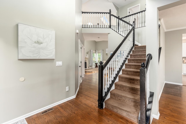 7774 Kingman Pl, Lewis Center, OH 43035 - staircase with wood finished floors and a high ceiling