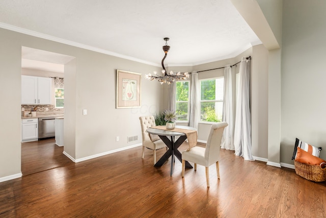 7774 Kingman Pl, Lewis Center, OH 43035 - dining space with a chandelier, healthy amount of natural light, crown molding, and wood finished floors
