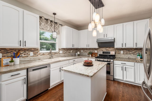 7774 Kingman Pl, Lewis Center, OH 43035 - kitchen featuring stainless steel appliances, decorative backsplash, white cabinets, and a center island