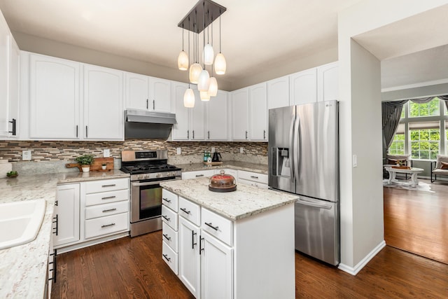 7774 Kingman Pl, Lewis Center, OH 43035 - kitchen with appliances with stainless steel finishes, under cabinet range hood, dark wood-style floors, and decorative backsplash