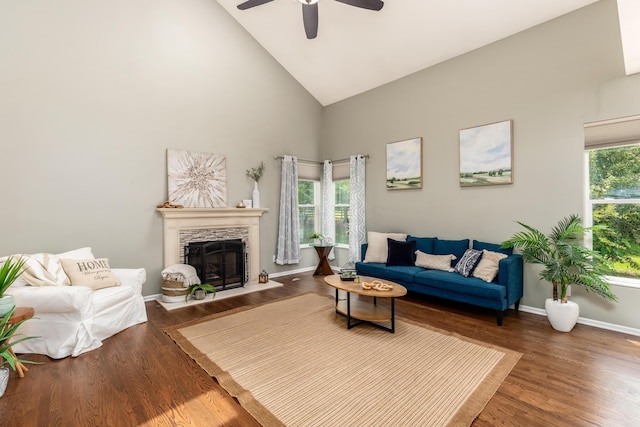7774 Kingman Pl, Lewis Center, OH 43035 - living area with high vaulted ceiling, a ceiling fan, a stone fireplace, and wood finished floors