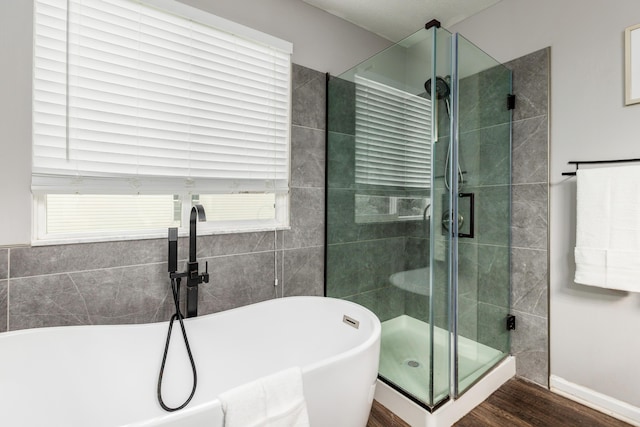 7774 Kingman Pl, Lewis Center, OH 43035 - full bathroom featuring a soaking tub, wood finished floors, and a shower stall
