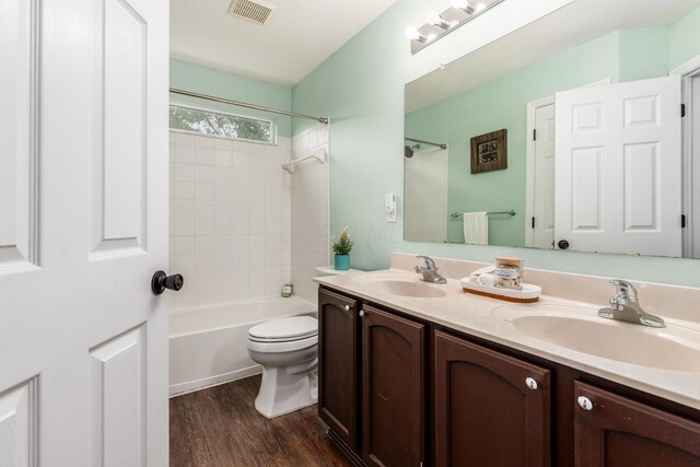 7774 Kingman Pl, Lewis Center, OH 43035 - bathroom featuring double vanity, wood finished floors, and shower / tub combination
