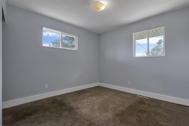 3749 Dort Pl, Columbus, OH 43227 - spare room with baseboards and dark carpet
