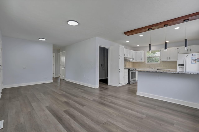 3749 Dort Pl, Columbus, OH 43227 - kitchen with white refrigerator with ice dispenser, stainless steel stove, white cabinetry, dark wood-type flooring, and recessed lighting