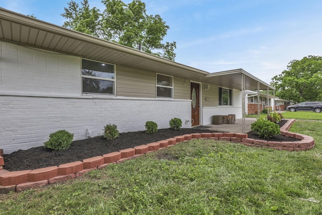 3749 Dort Pl, Columbus, OH 43227 - view of front of house featuring a front yard, brick siding, and a patio