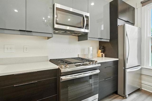 626 S 22nd St, Columbus, OH 43205 - kitchen with appliances with stainless steel finishes, modern cabinets, light countertops, and light wood-style floors