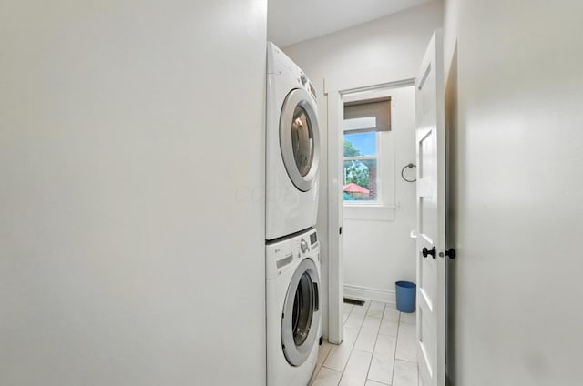 626 S 22nd St, Columbus, OH 43205 - washroom featuring stacked washer / dryer and light tile patterned floors