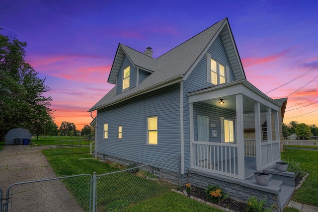 1332 E Deshler Ave, Columbus, OH 43206 - view of home's exterior with covered porch, a chimney, a gate, and a storage shed