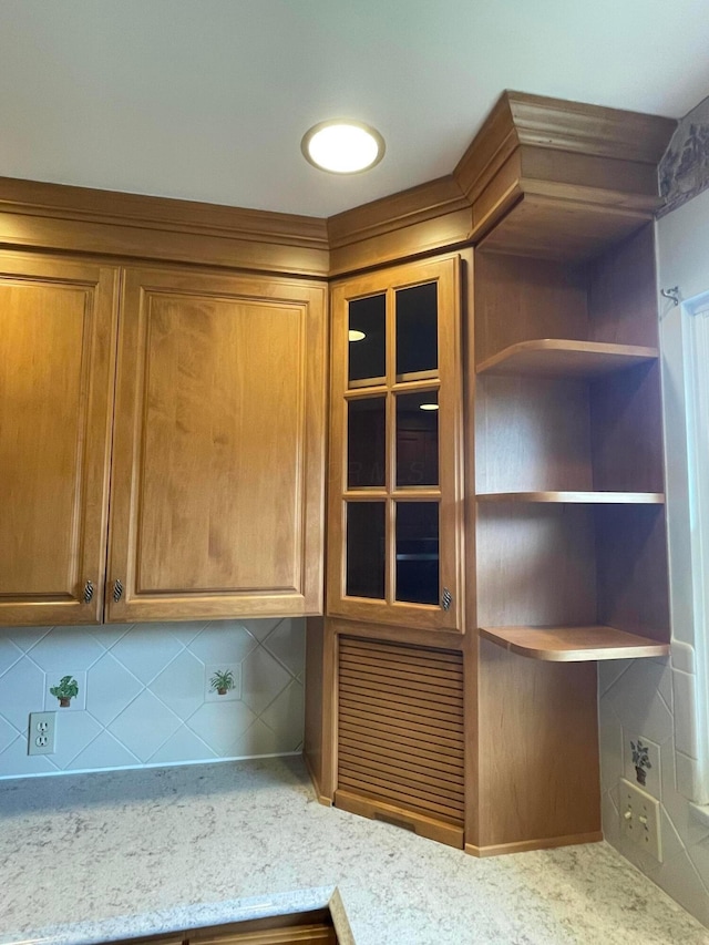 2666 Eugene Ave, Grove City, OH 43123 - kitchen view of brown cabinetry, glass insert cabinets, and light stone counters