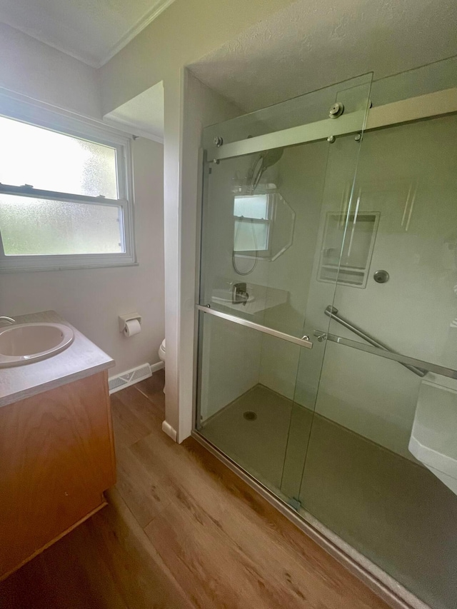 2666 Eugene Ave, Grove City, OH 43123 - bathroom with wood finished floors, a shower stall, vanity, and ornamental molding