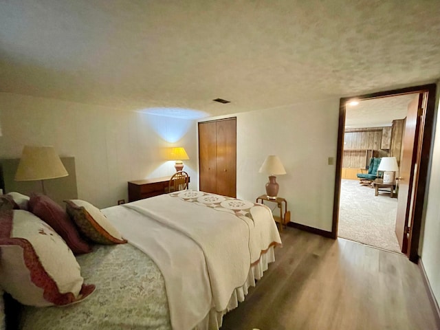 2666 Eugene Ave, Grove City, OH 43123 - bedroom featuring wood finished floors, a textured ceiling, and a closet