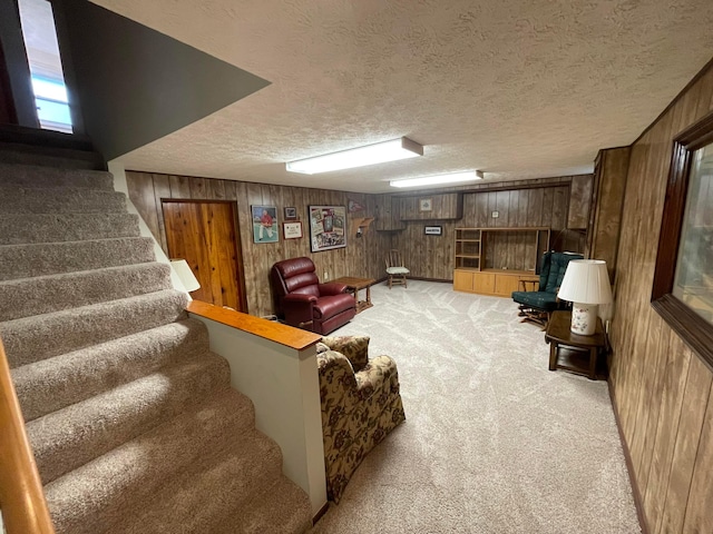 2666 Eugene Ave, Grove City, OH 43123 - living room with wood walls, light colored carpet, stairway, and a textured ceiling