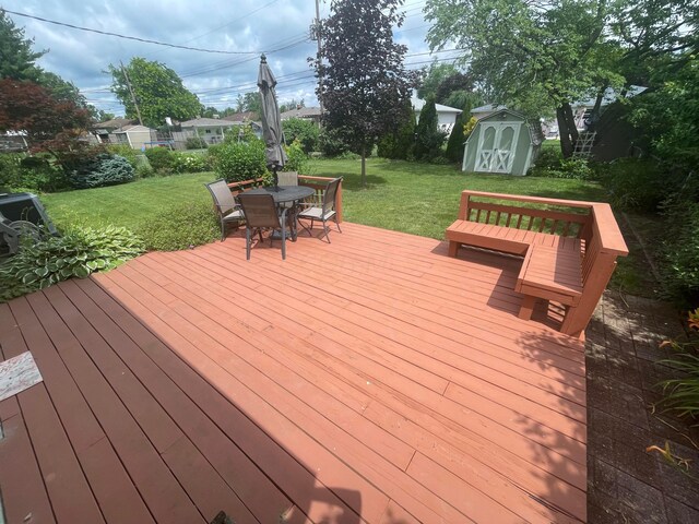 2666 Eugene Ave, Grove City, OH 43123 - wooden deck featuring a storage unit, a lawn, and outdoor dining area