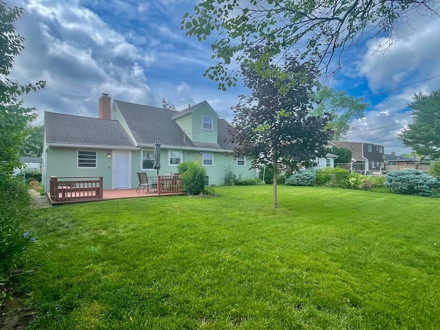 2666 Eugene Ave, Grove City, OH 43123 - rear view of house with a chimney, a yard, a wooden deck, and a shingled roof