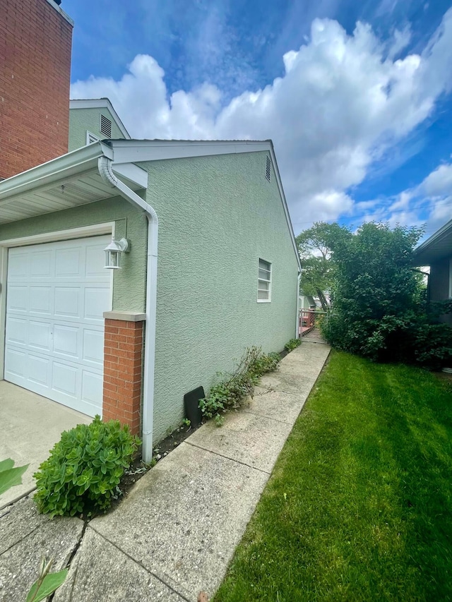 2666 Eugene Ave, Grove City, OH 43123 - view of property exterior featuring stucco siding, a yard, and an attached garage