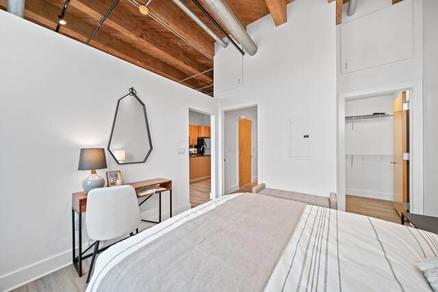 150 E Main St Unit 512, Columbus, OH 43215 - bedroom featuring electric panel, wood finished floors, a wood ceiling with exposed beams, and a closet