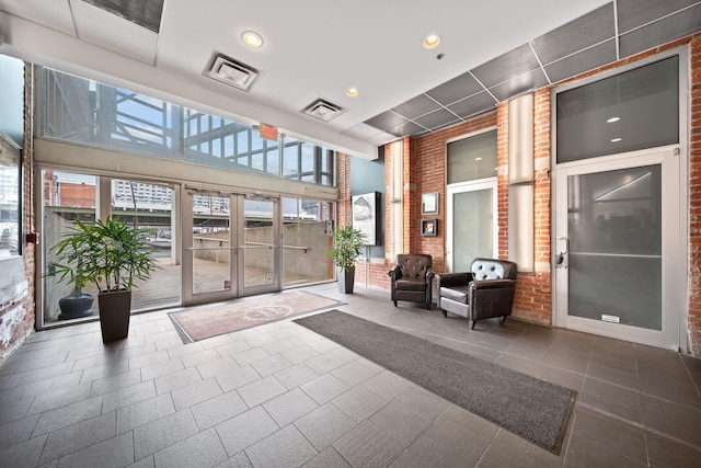 150 E Main St Unit 512, Columbus, OH 43215 - community lobby featuring brick wall, recessed lighting, and a towering ceiling
