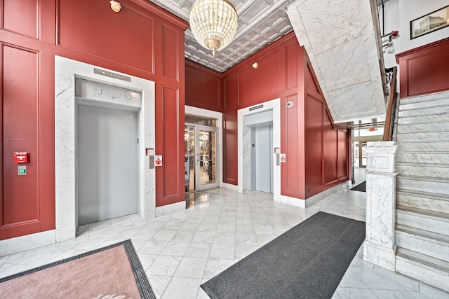 150 E Main St Unit 512, Columbus, OH 43215 - building lobby with stairway, a towering ceiling, and a decorative wall