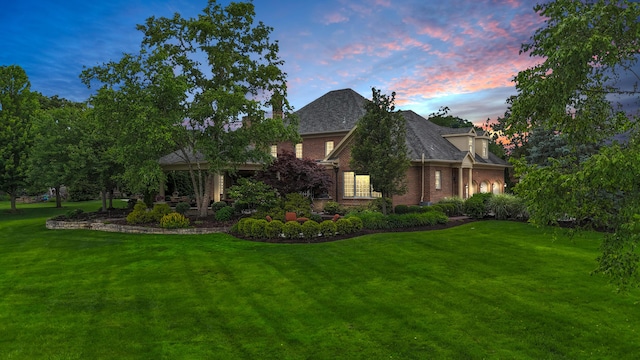 10277 Mackenzie Way, Dublin, OH 43017 - view of front of house featuring a front lawn, brick siding, and roof with shingles