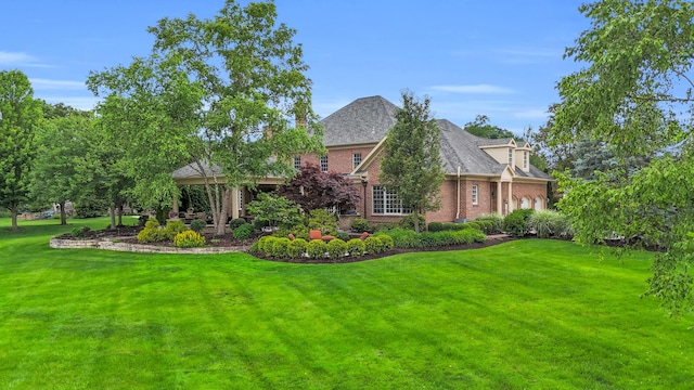 10277 Mackenzie Way, Dublin, OH 43017 - view of front of house with brick siding, a front lawn, and a shingled roof