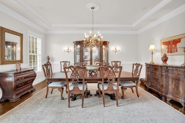 10277 Mackenzie Way, Dublin, OH 43017 - dining space featuring a tray ceiling, dark wood-style floors, a chandelier, and ornamental molding