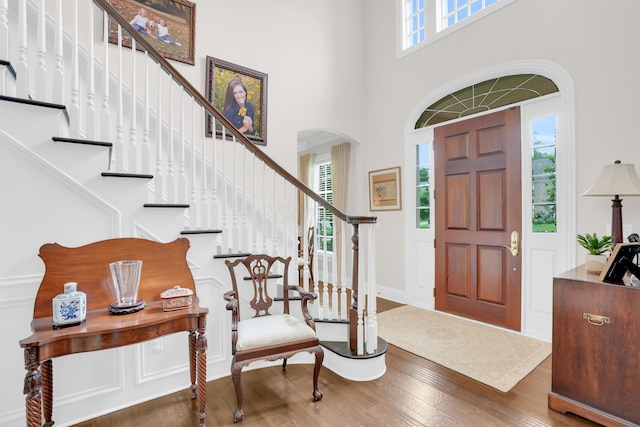 10277 Mackenzie Way, Dublin, OH 43017 - entrance foyer featuring wood finished floors, arched walkways, a high ceiling, and stairs