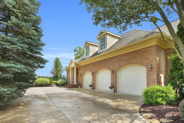 10277 Mackenzie Way, Dublin, OH 43017 - view of side of property with brick siding, concrete driveway, and roof with shingles