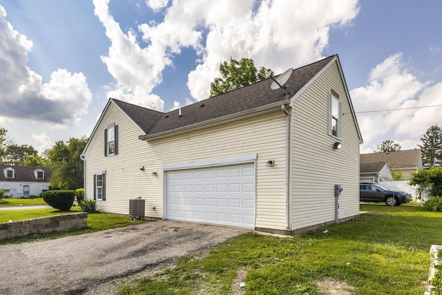 1664 S Champion Ave, Columbus, OH 43207 - view of side of home with asphalt driveway, a lawn, and roof with shingles