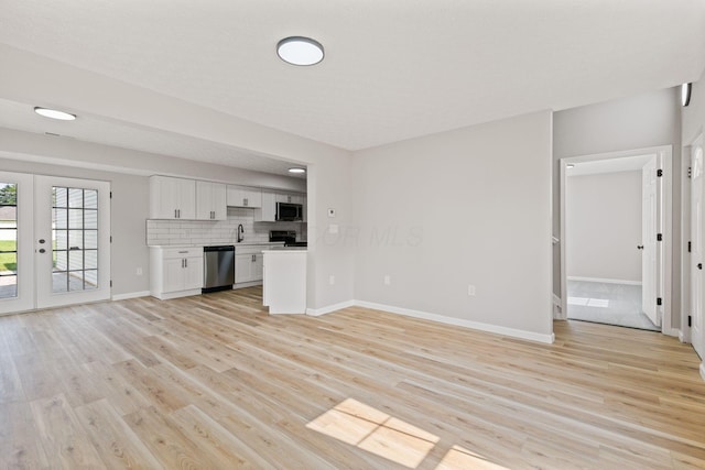 1664 S Champion Ave, Columbus, OH 43207 - unfurnished living room with light wood-style floors and french doors