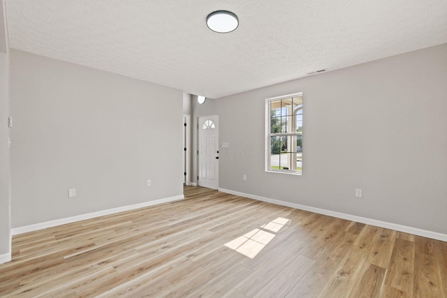 1664 S Champion Ave, Columbus, OH 43207 - spare room with a textured ceiling and light wood-style flooring
