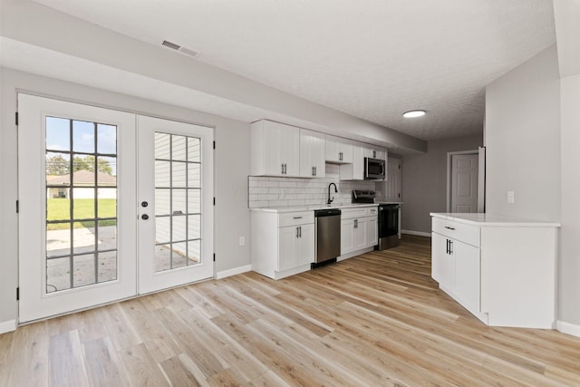 1664 S Champion Ave, Columbus, OH 43207 - kitchen with stainless steel appliances, light countertops, french doors, and light wood finished floors