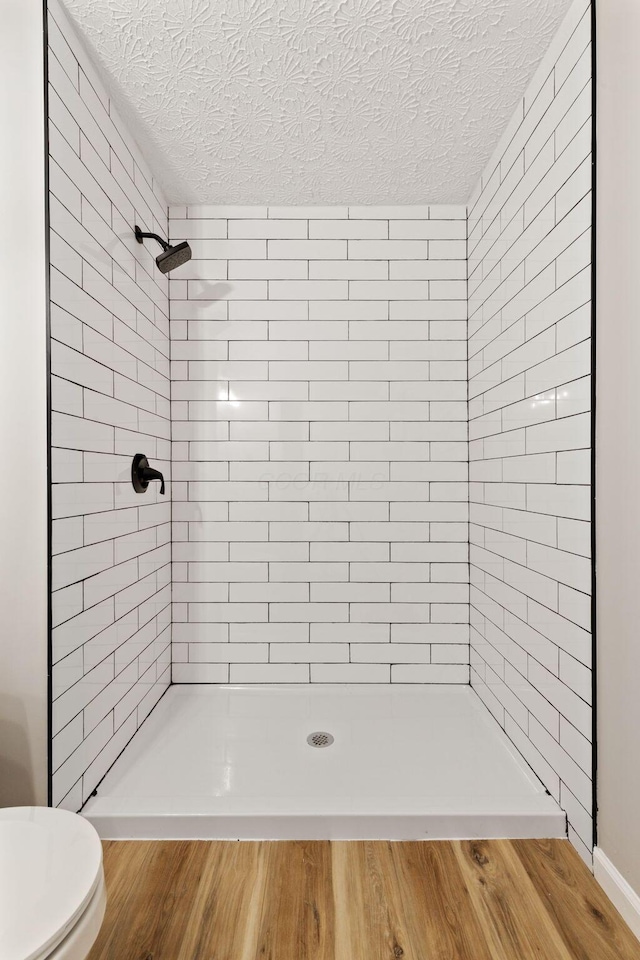 1664 S Champion Ave, Columbus, OH 43207 - full bath featuring a stall shower, a textured ceiling, and wood finished floors