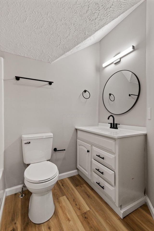 1664 S Champion Ave, Columbus, OH 43207 - bathroom featuring wood finished floors, vanity, and a textured ceiling