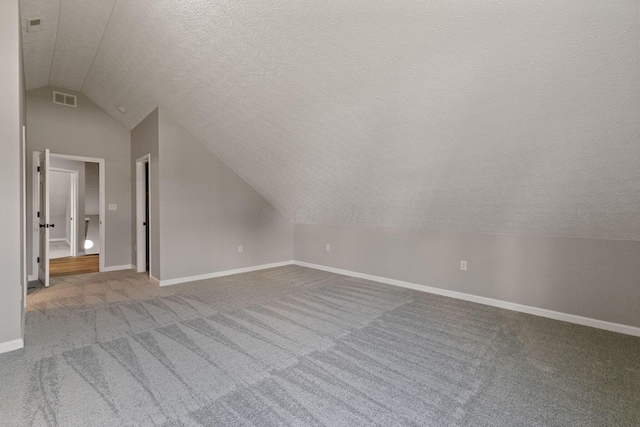 1664 S Champion Ave, Columbus, OH 43207 - additional living space featuring lofted ceiling, a textured ceiling, and carpet floors