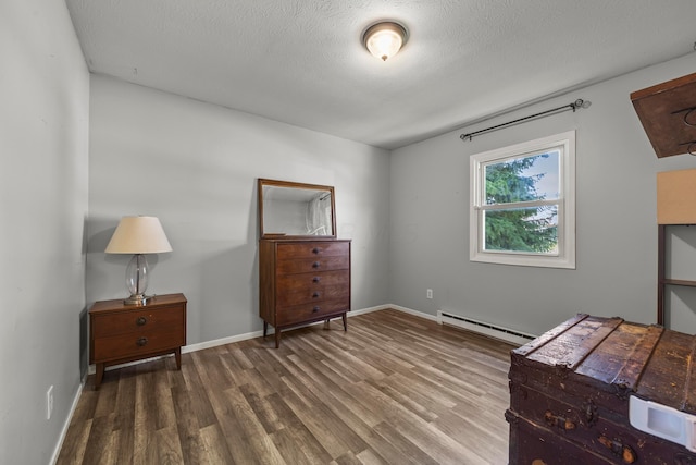876 Kirkwood Dr, West Jefferson, OH 43162 - unfurnished bedroom with a baseboard radiator, wood finished floors, and a textured ceiling